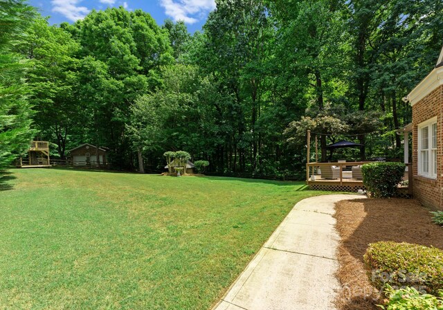328 Whippoorwill Rd, Mooresville, NC 28117 - view of grassy yard with a deck
