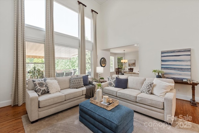 7507 Meadowgate Ln, Waxhaw, NC 28173 - living room featuring baseboards, wood finished floors, and a towering ceiling