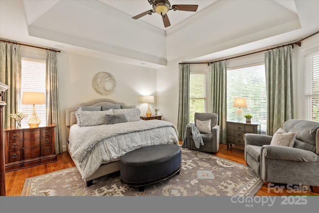 7507 Meadowgate Ln, Waxhaw, NC 28173 - bedroom featuring a raised ceiling, wood finished floors, ceiling fan, and crown molding