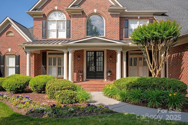 7507 Meadowgate Ln, Waxhaw, NC 28173 - view of front of house featuring brick siding, french doors, a porch, and a standing seam roof