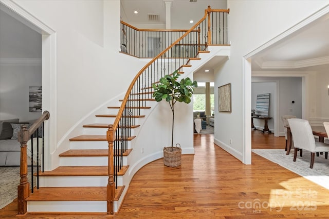 7507 Meadowgate Ln, Waxhaw, NC 28173 - stairs with crown molding, wood finished floors, a high ceiling, and baseboards