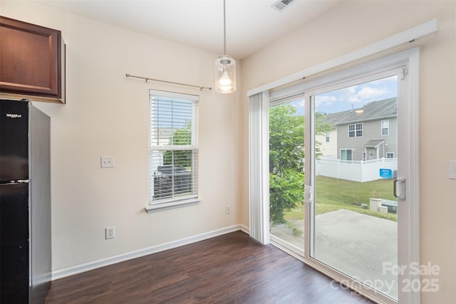 13612 Singleleaf Ln, Charlotte, NC 28278 - unfurnished dining area with dark wood-style floors and baseboards