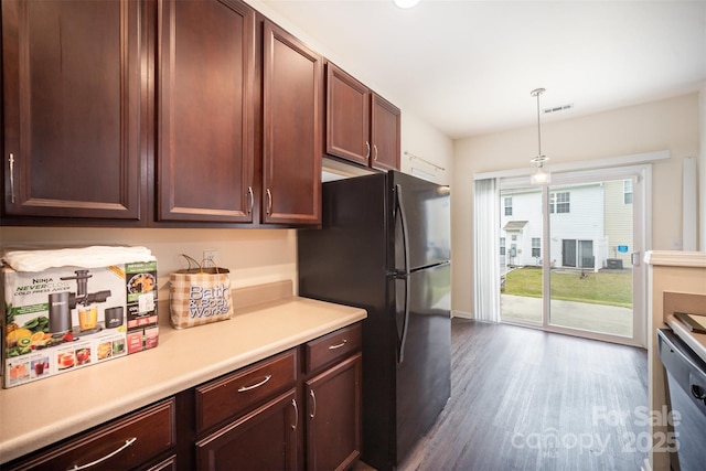 13612 Singleleaf Ln, Charlotte, NC 28278 - kitchen with freestanding refrigerator, light countertops, dark wood-type flooring, stainless steel dishwasher, and decorative light fixtures