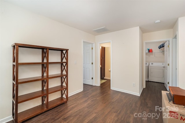 13612 Singleleaf Ln, Charlotte, NC 28278 - unfurnished bedroom with washer and dryer, dark wood-style flooring, baseboards, and a spacious closet