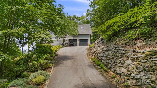 5 Saddle Rdg, Fletcher, NC 28732 - obstructed view of property featuring a garage, asphalt driveway, and roof with shingles