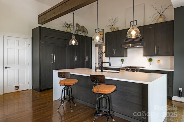 5 Saddle Rdg, Fletcher, NC 28732 - kitchen with high vaulted ceiling, under cabinet range hood, light countertops, dark wood-style flooring, and a breakfast bar area