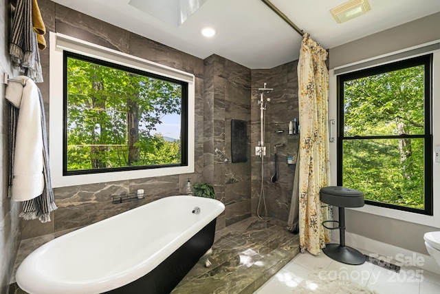 5 Saddle Rdg, Fletcher, NC 28732 - full bathroom featuring a freestanding bath, marble tiled floors, a stall shower, and tile walls