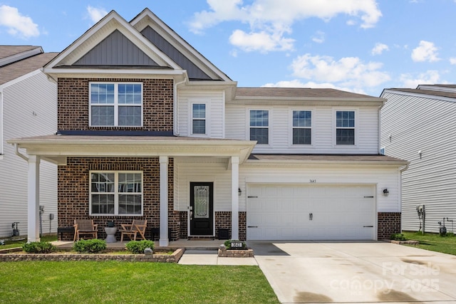 view of front of property featuring brick siding, a porch, board and batten siding, and concrete driveway