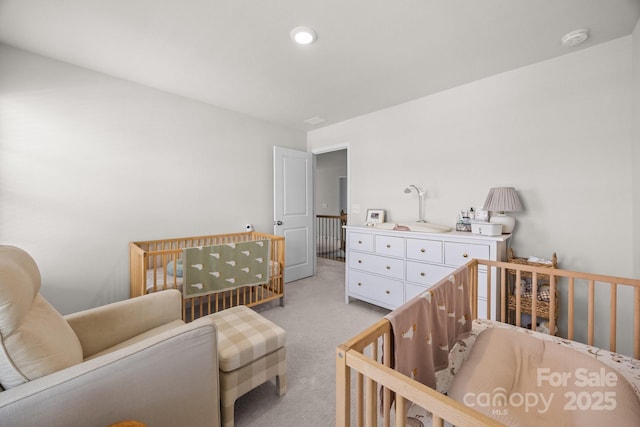 bedroom with light carpet and a crib