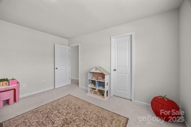 rec room with carpet flooring and baseboards