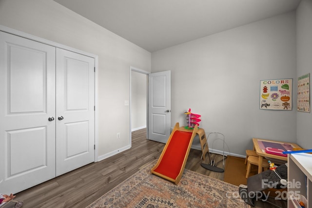 rec room with wood finished floors and baseboards