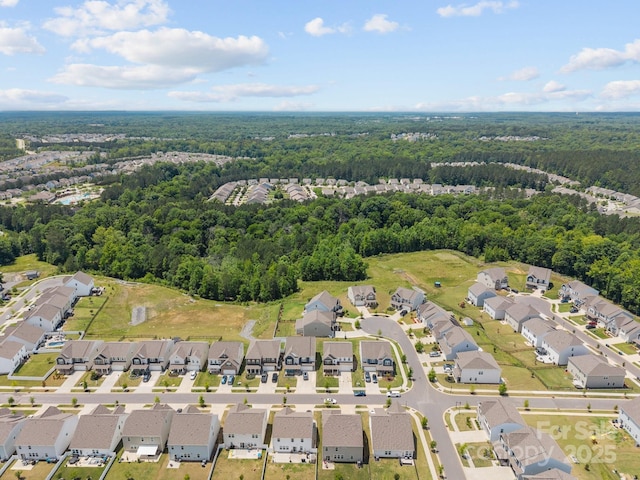 aerial overview of property's location featuring a heavily wooded area and nearby suburban area