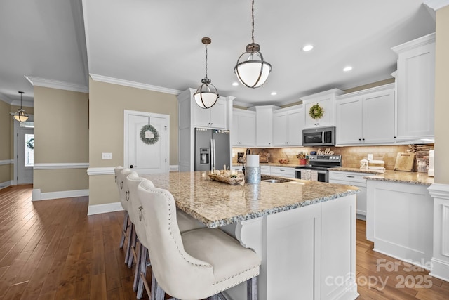335 Wintergreen Ct, Kings Mountain, NC 28086 - kitchen with appliances with stainless steel finishes, backsplash, white cabinets, a sink, and crown molding