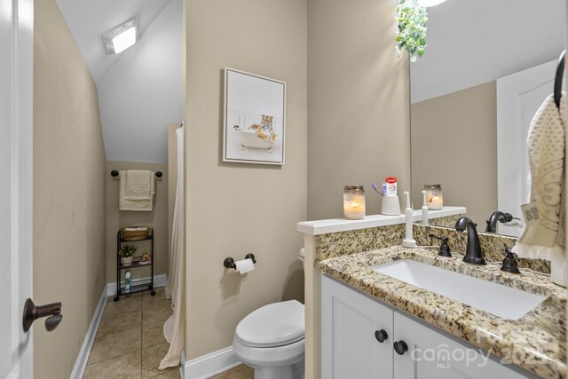 335 Wintergreen Ct, Kings Mountain, NC 28086 - bathroom with toilet, lofted ceiling, vanity, baseboards, and tile patterned floors