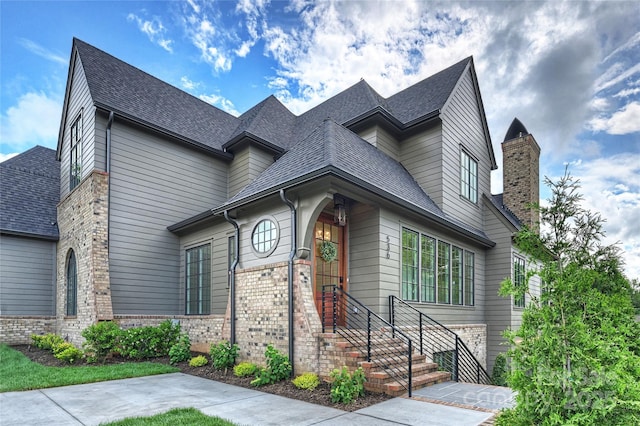536 Hillside Ave, Charlotte, NC 28209 - view of front of house with brick siding, a chimney, and a shingled roof