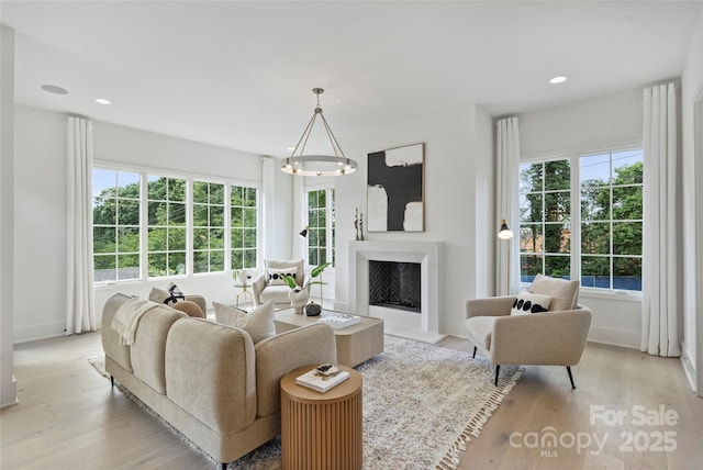 536 Hillside Ave, Charlotte, NC 28209 - living room with healthy amount of natural light, light wood-type flooring, a premium fireplace, and recessed lighting