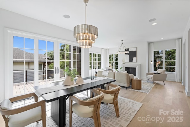 536 Hillside Ave, Charlotte, NC 28209 - dining area featuring healthy amount of natural light, light wood finished floors, a chandelier, recessed lighting, and baseboards