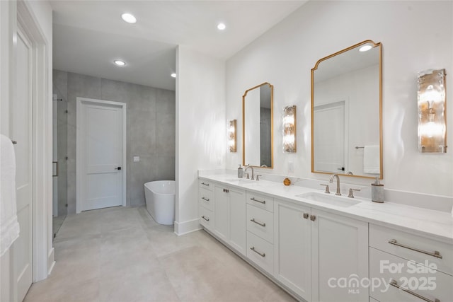 536 Hillside Ave, Charlotte, NC 28209 - full bathroom featuring double vanity, a soaking tub, a stall shower, and recessed lighting