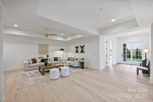 536 Hillside Ave, Charlotte, NC 28209 - living area with a tray ceiling, baseboards, light wood finished floors, recessed lighting, and a ceiling fan
