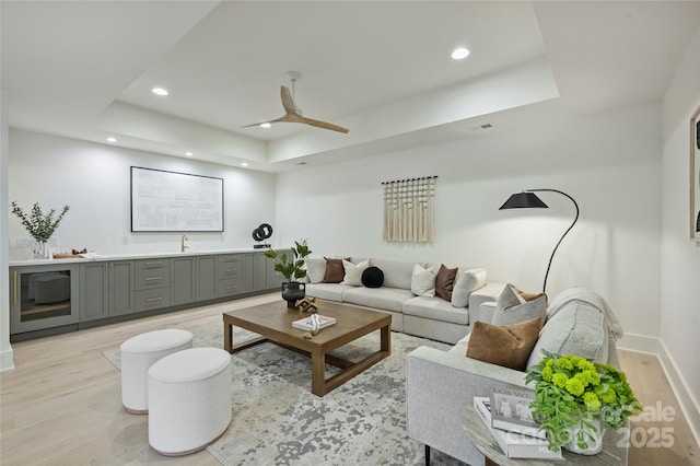 536 Hillside Ave, Charlotte, NC 28209 - living room featuring light wood-style floors, a raised ceiling, recessed lighting, a ceiling fan, and baseboards