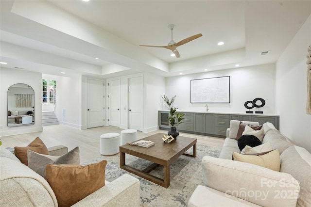 536 Hillside Ave, Charlotte, NC 28209 - living room featuring recessed lighting, a raised ceiling, light wood finished floors, a ceiling fan, and stairway