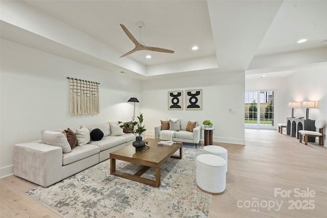 536 Hillside Ave, Charlotte, NC 28209 - living room with baseboards, light wood-style flooring, a tray ceiling, a ceiling fan, and recessed lighting