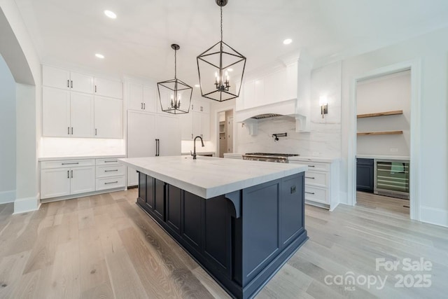 306 Sugar Maple Ln, Weddington, NC 28104 - kitchen with beverage cooler, tasteful backsplash, premium range hood, light wood-style floors, and recessed lighting