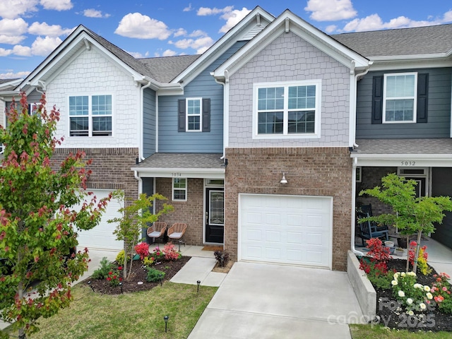 5034 Moss Pine Way, Tega Cay, SC 29708 - view of front of property featuring brick siding, concrete driveway, roof with shingles, and a garage