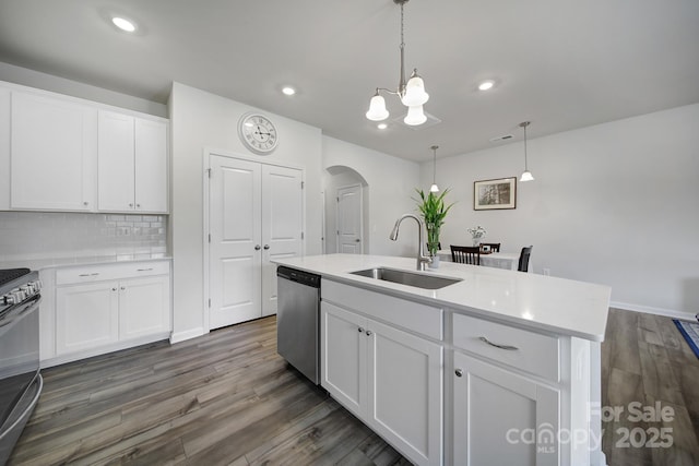 5034 Moss Pine Way, Tega Cay, SC 29708 - kitchen with stainless steel appliances, a sink, arched walkways, dark wood finished floors, and recessed lighting