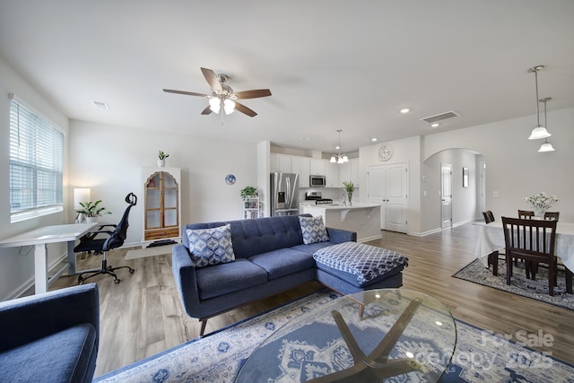 5034 Moss Pine Way, Tega Cay, SC 29708 - living room with arched walkways, light wood finished floors, ceiling fan, baseboards, and recessed lighting