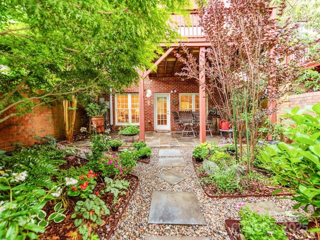3044 Luke Crossing Dr, Charlotte, NC 28226 - property entrance featuring brick siding, a patio, and a wooden deck
