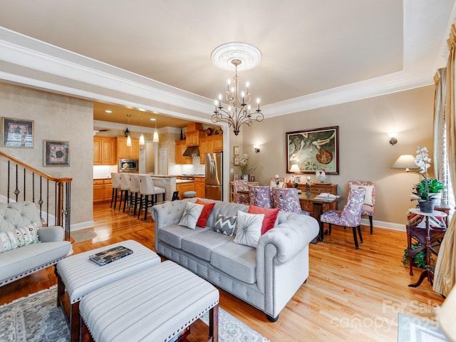 3044 Luke Crossing Dr, Charlotte, NC 28226 - living area featuring a chandelier, baseboards, ornamental molding, and light wood finished floors
