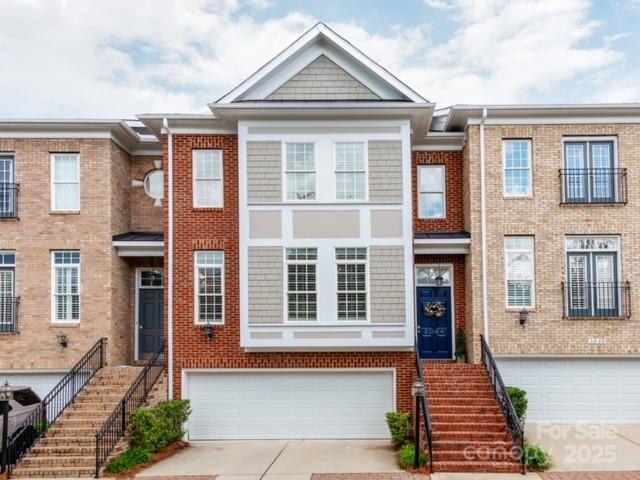 3044 Luke Crossing Dr, Charlotte, NC 28226 - multi unit property with an attached garage, concrete driveway, stairway, and brick siding