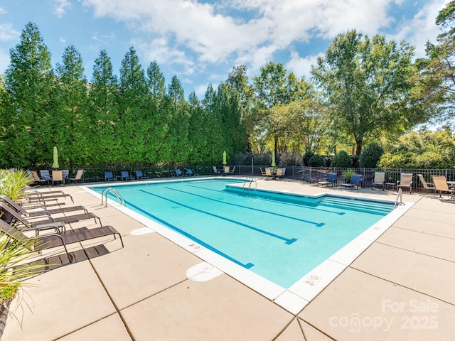 3044 Luke Crossing Dr, Charlotte, NC 28226 - community pool featuring a patio and view of scattered trees