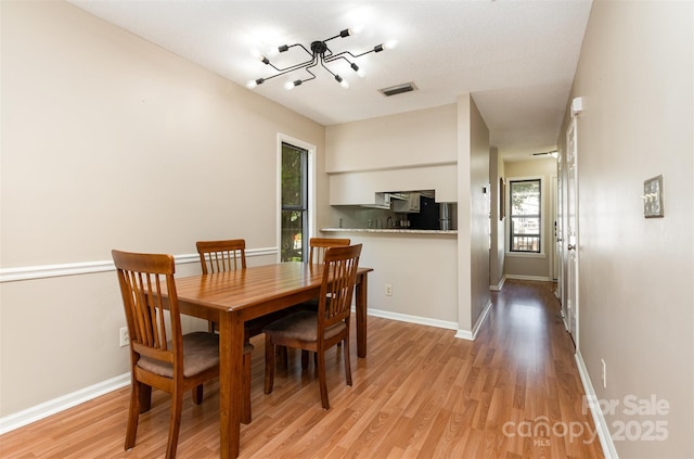 216 S Clarkson St Unit E, Charlotte, NC 28202 - dining space with light wood-type flooring and baseboards