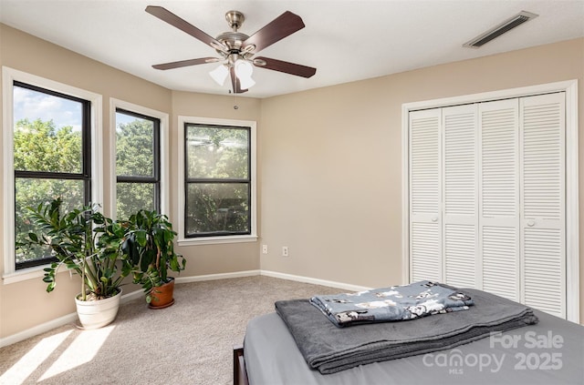 216 S Clarkson St Unit E, Charlotte, NC 28202 - carpeted bedroom featuring baseboards, a closet, and ceiling fan