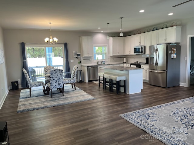 1119 Balls Creek Rd, Claremont, NC 28610 - kitchen with appliances with stainless steel finishes, a chandelier, a kitchen island, white cabinetry, and recessed lighting