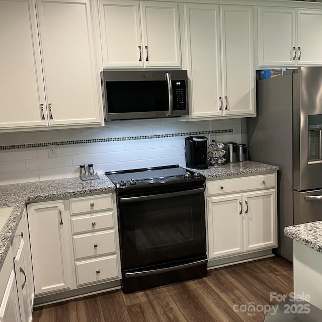 1119 Balls Creek Rd, Claremont, NC 28610 - kitchen with stainless steel appliances, white cabinets, dark wood-type flooring, and backsplash