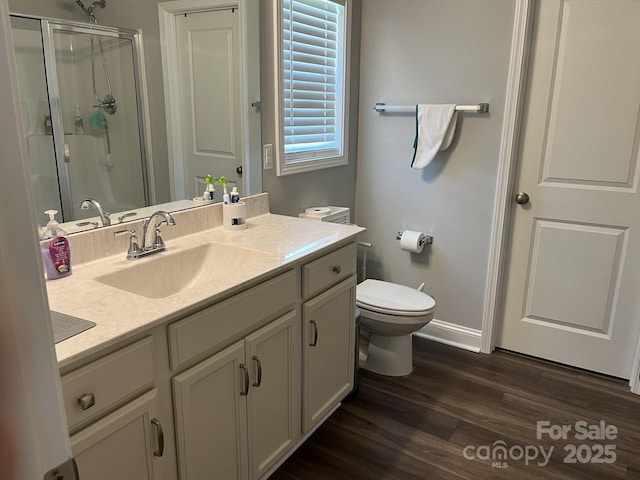 1119 Balls Creek Rd, Claremont, NC 28610 - bathroom with baseboards, a shower stall, wood finished floors, toilet, and vanity