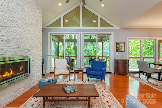 201 Ruffed Grouse Ln, Waynesville, NC 28786 - living area with wood finished floors, a fireplace, and high vaulted ceiling
