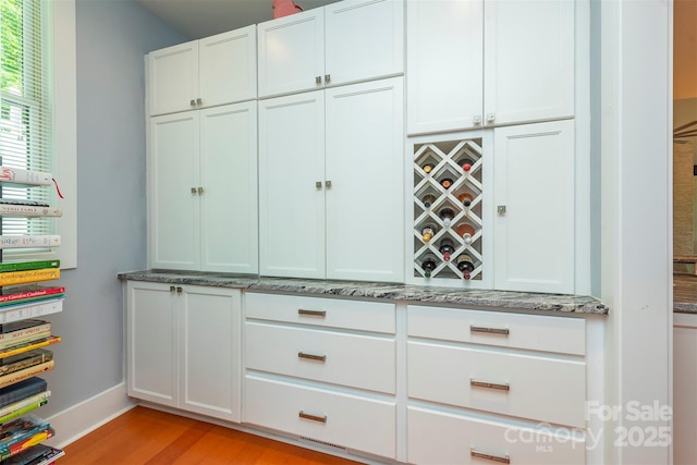 201 Ruffed Grouse Ln, Waynesville, NC 28786 - bar with light wood finished floors and baseboards