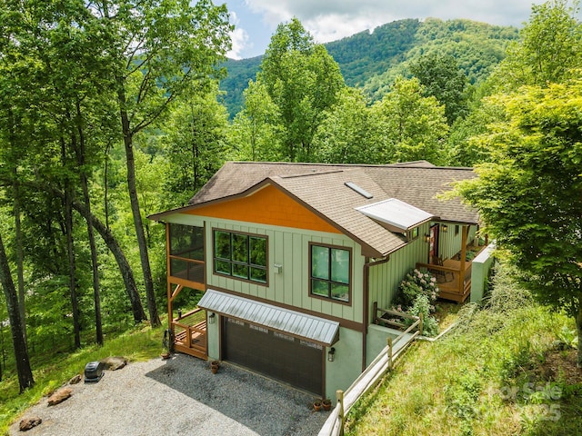 201 Ruffed Grouse Ln, Waynesville, NC 28786 - rustic home with a shingled roof, gravel driveway, a wooded view, and a garage