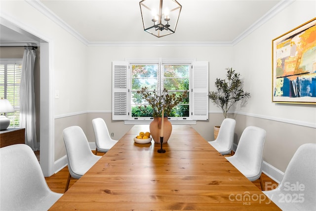 5162 Lincrest Pl, Charlotte, NC 28211 - dining room with a chandelier, plenty of natural light, ornamental molding, wood finished floors, and baseboards