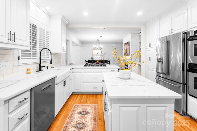 5162 Lincrest Pl, Charlotte, NC 28211 - kitchen featuring stainless steel appliances, a center island, tasteful backsplash, white cabinetry, and light wood-style floors