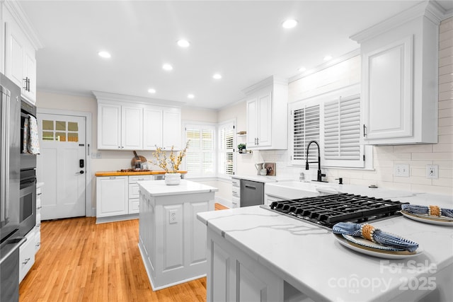 5162 Lincrest Pl, Charlotte, NC 28211 - kitchen featuring a sink, white cabinets, ornamental molding, backsplash, and recessed lighting
