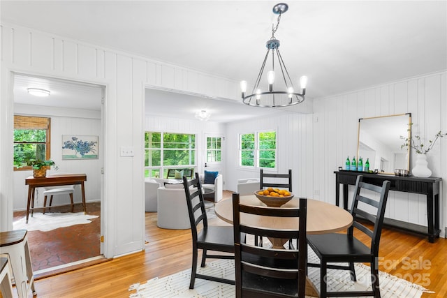5162 Lincrest Pl, Charlotte, NC 28211 - dining area featuring plenty of natural light, a chandelier, light wood finished floors, and a decorative wall