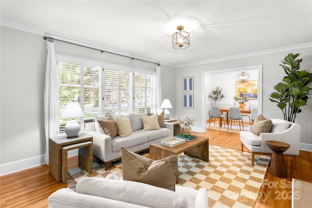 5162 Lincrest Pl, Charlotte, NC 28211 - living area featuring light wood finished floors, baseboards, ornamental molding, and a chandelier