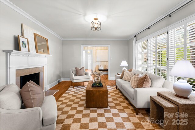 5162 Lincrest Pl, Charlotte, NC 28211 - living room with light wood-type flooring, crown molding, baseboards, and a fireplace