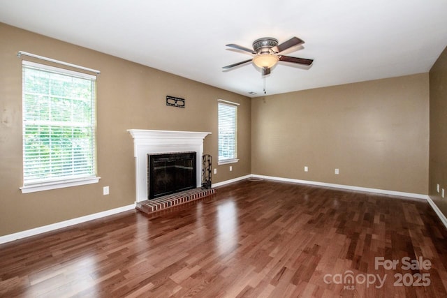 292 Rose St, Mooresville, NC 28117 - unfurnished living room featuring a ceiling fan, a glass covered fireplace, wood finished floors, and baseboards