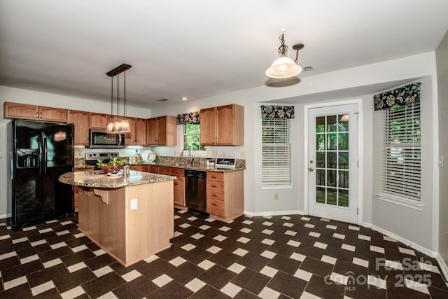292 Rose St, Mooresville, NC 28117 - kitchen with black appliances, dark flooring, baseboards, decorative light fixtures, and a kitchen island